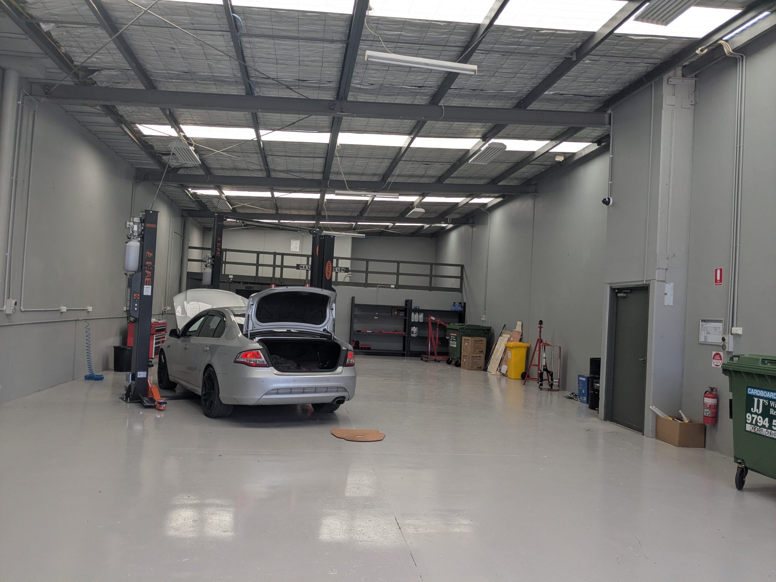 Logbook Servicing Clyde North and Berwick — silver sedan inside a Carcare Services workshop